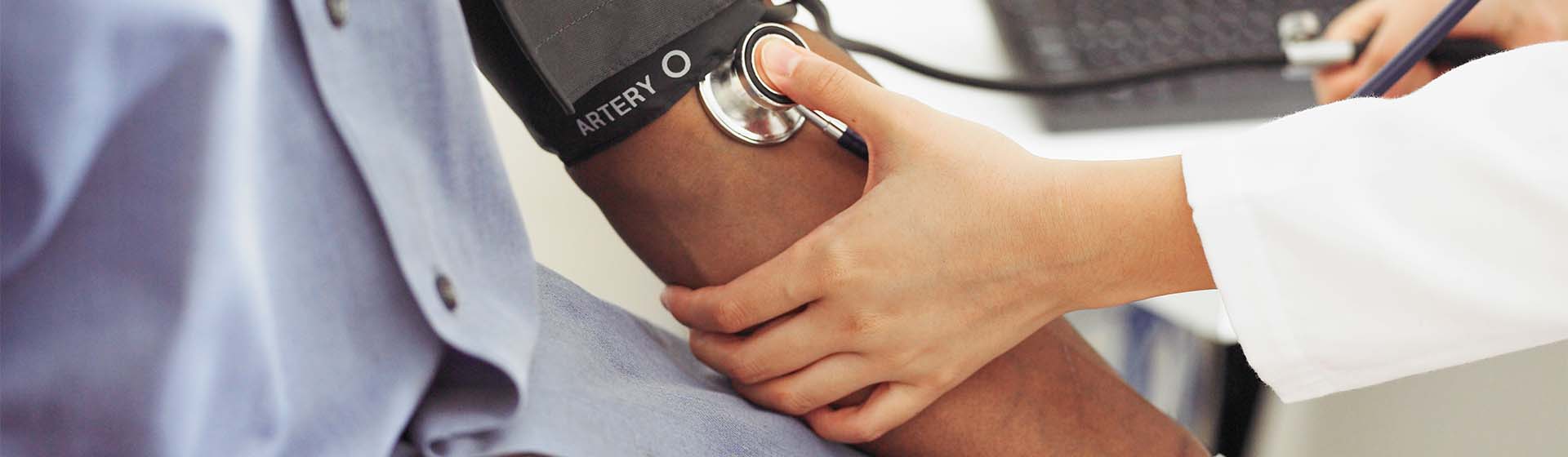 Provider measuring patient's blood pressure
