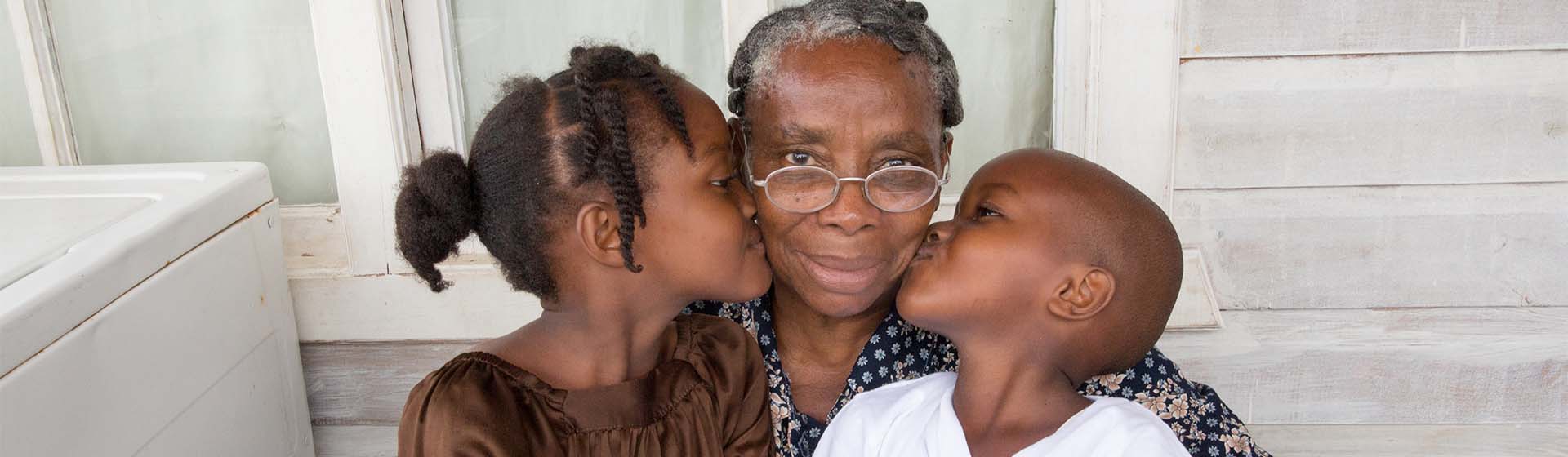 Grandmother embracing her two grandchildren