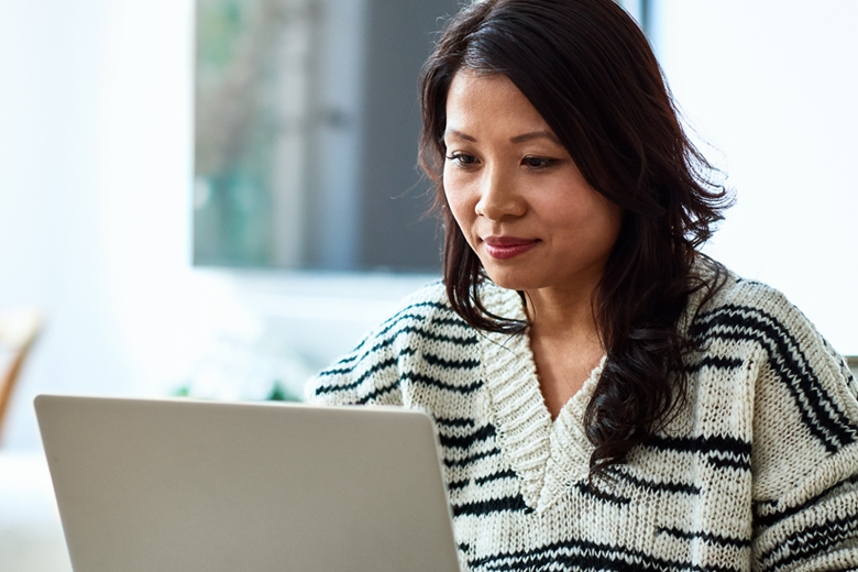 Woman using laptop to manage care online