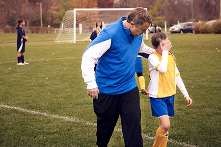 A youth athlete leaves the field with an injury.