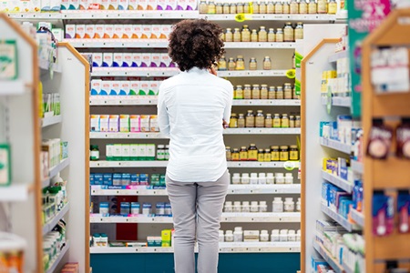 A woman examines the supplement aisle.