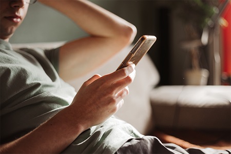 A man reads on a smartphone.