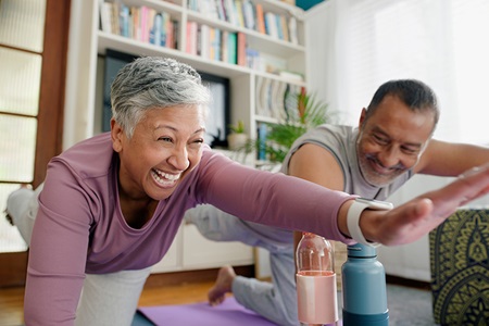 A man and woman practice yoga.