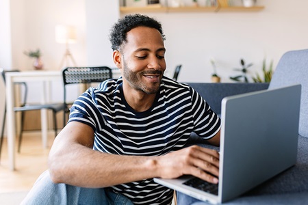 A man types at a computer.