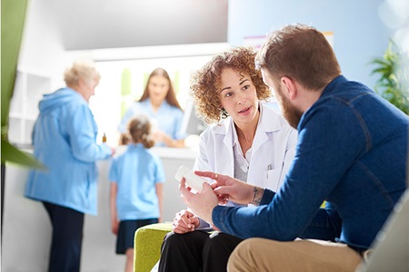 A man and a woman talk in the pharmacy