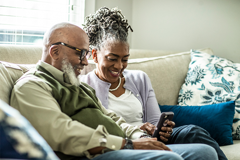 Older couple looks at phone together