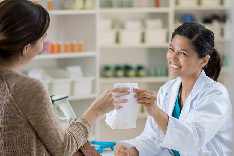 Pharmacist gives a customer their prescription