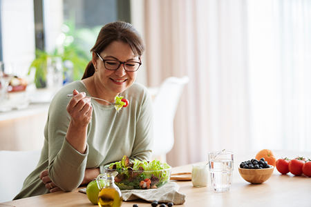 A woman eats a healthy meal.