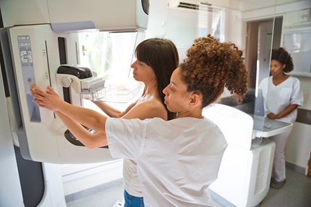 Nurse showing patient mammogram